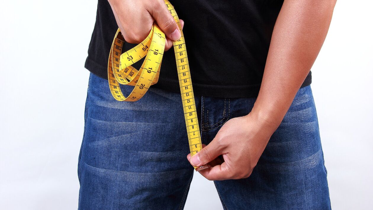 man measures penis before enlargement
