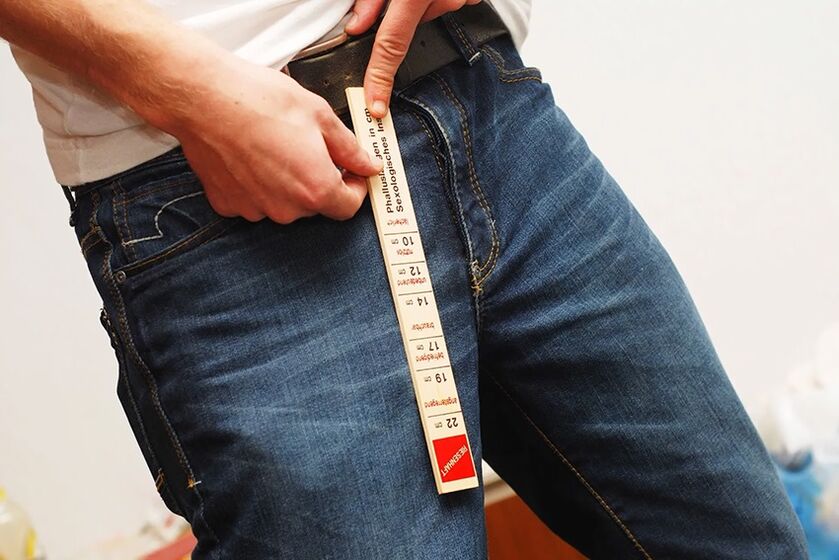 man measures penis before enlargement